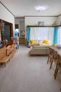 a living room with a couch and a table at Lagoon藍yoron 一棟貸し in Yoron