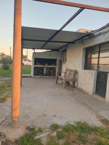 a bench under awning outside of a building at Don Ramón in Colonia del Sacramento