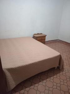 a bedroom with a bed and a wooden table at Don Ramón in Colonia del Sacramento