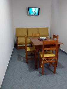 a dining room table and chairs with a couch at Tomás in Mar de Ajó