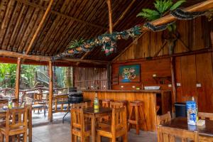 a dining room with wooden tables and chairs at Cabañas SyC in Fortuna
