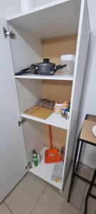 a white pantry door with a pan on it at Depa más pileta en Ypane in Ypane