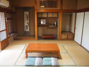 a room with a wooden table in a room at Ichie in Tanabe