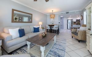 a living room with a couch and a table at Phoenix III 3126 in Orange Beach