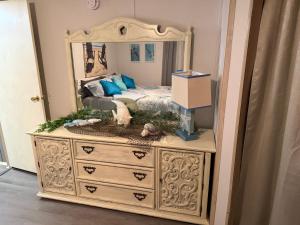 a dresser with a mirror on top of it at The Revival Retreat in Gloucester
