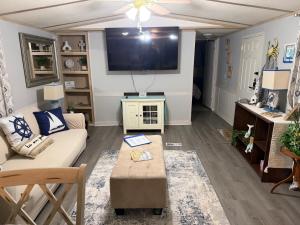 a living room with a couch and a tv at The Revival Retreat in Gloucester