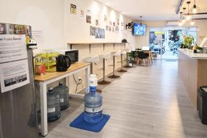 a restaurant with a row of water bottles on the floor at KPOP Hostel in Karon Beach