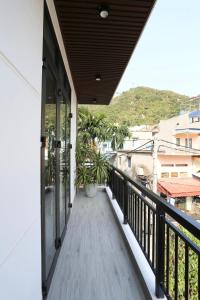 a balcony of a house with plants on it at VITA Homestay in Cat Ba
