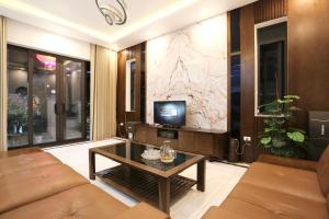 a living room with a couch and a tv at VITA Homestay in Cat Ba