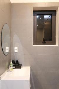 a bathroom with a sink and a mirror at VITA Homestay in Cat Ba +6 photos