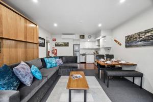a living room with a couch and a table at Lantern 05 - Balcony in Thredbo