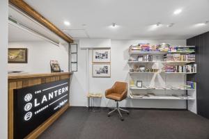 a library with a chair and a book shelf at Lantern 05 - Balcony in Thredbo