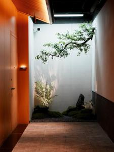 a hallway with a wall with a tree on it at a1 Art Hotel in Quanzhou