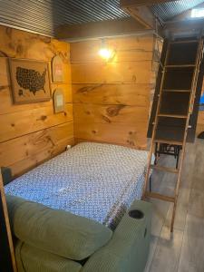 a bedroom with a bunk bed and a ladder at Cozy little Cabin in Van Buren