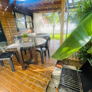 a patio with a table and chairs on a deck at Kit luxo com spa aquecido in Florianópolis