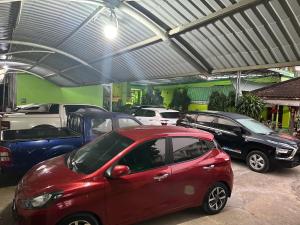 a red car parked in a garage with other cars at Tan My Thien Hotel in Tây Ninh