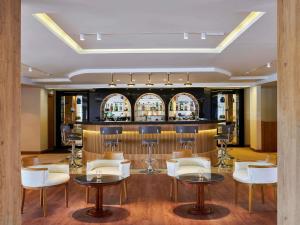 a restaurant with tables and chairs and a bar at Mövenpick Royal Lotus Nile Cruise, Every Monday Four Nights From Luxor, Every Friday Three Nights From Aswan in Luxor