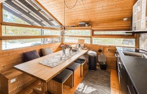 a kitchen with a wooden table in a tiny house at Amazing Home In Eggedal With Wifi in Eggedal
