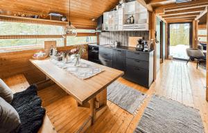 a kitchen and living room with a table in a cabin at Amazing Home In Eggedal With Wifi in Eggedal