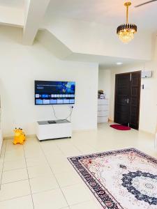 a living room with a tv on the wall at SM Guest House in Changlun +20 photos