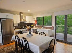 a kitchen with a table and chairs in a kitchen at Narrow Neck Views - Peaceful 4 Bedroom Home with Stunning Views! in Katoomba +37 photos