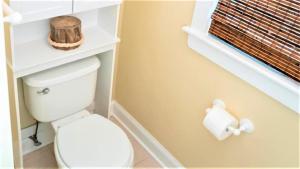 a bathroom with a toilet and a roll of toilet paper at Gray Cottage On Windsor in Cape May