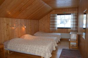 Postel nebo postele na pokoji v ubytování Rinnepelto Holiday Cottages