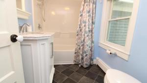 a bathroom with a toilet and a sink and a shower at Heritage House 2 in Cape May +19 photos