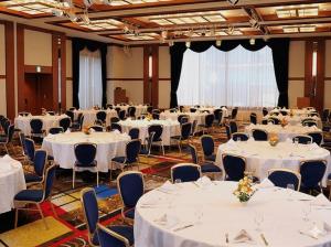 a banquet hall with white tables and chairs at Hotel Keihan Universal Tower in Osaka