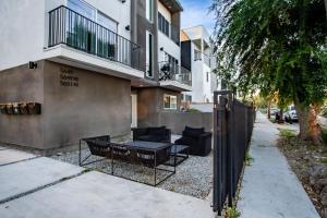 a patio with black furniture in front of a building at Emerald Elephas at Case Collective in North Hollywood