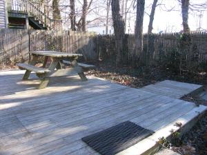 a picnic table sitting on top of a wooden deck at The Elmira Escape in Cape May