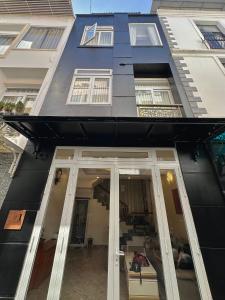 a blue building with glass doors and windows at 1 House 2 in Da Lat