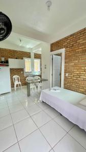 a large room with a large bed and a kitchen at Chalés Santo Antônio em Flecheiras in Flecheiras