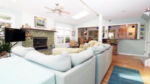 a living room with white couches and a fireplace at The Roost Ii On Leaming in West Cape May