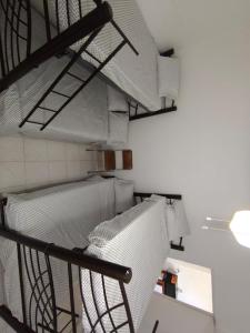 a room with a staircase with white walls and shelves at Bungalow privado con alberca Oaxtepec 14 personas in Oaxtepec