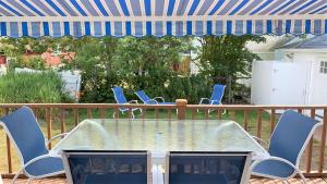 a patio table and chairs on a deck at Windsor Escape in Cape May