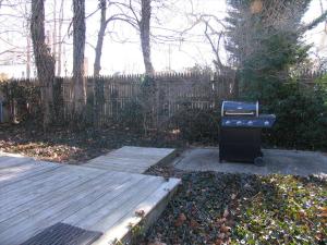 a barbecue grill sitting next to a wooden deck at The Elmira Escape in Cape May