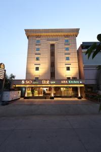 a large building with a sign in front of it at Sio Suites in Navi Mumbai