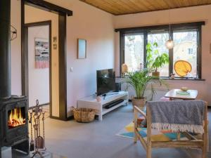a living room with a fireplace and a tv at 4 person holiday home in Tibro in Tibro