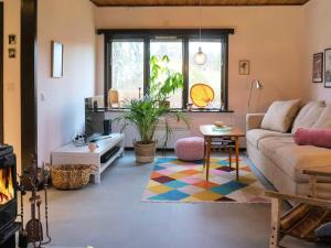 a living room with a couch and a table at 4 person holiday home in Tibro in Tibro +22 photos