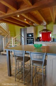 a kitchen with a large wooden table and chairs at Gîte la margeride 4 personnes in Julianges