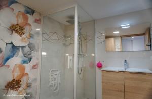 a shower with a glass door in a bathroom at Gîte la margeride 4 personnes in Julianges +22 photos