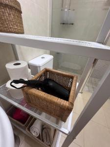 a wine bottle in a basket on a shelf in a bathroom at Real 92 in Arguedas +73 photos