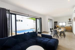 a living room with a blue couch and a table at Rocky 36 in Grand-Baie