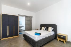 a bedroom with a large bed and a cabinet at Rocky 36 in Grand-Baie +7 photos