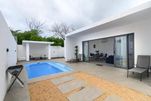 a swimming pool in the backyard of a house at Rocky 36 in Grand-Baie