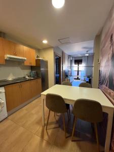 a kitchen with a table and chairs in a room at Real 92 in Arguedas