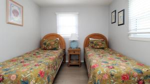 two beds sitting next to each other in a room at 12 Mechanic St in West Cape May