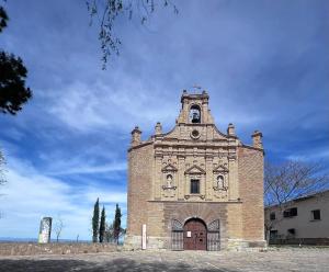an old brick building with a bell tower at Real 92 in Arguedas