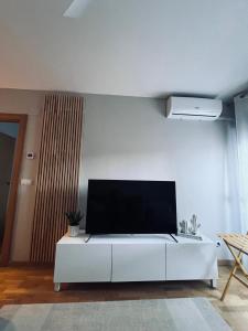 a living room with a tv on a white wall at Real 92 in Arguedas